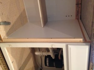 Adding pine strips to secure the new face frame to the cabinet box.