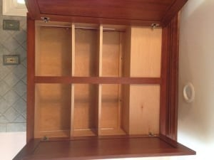 The top of this cabinet was modified to hide plumbing that couldn’t be moved.