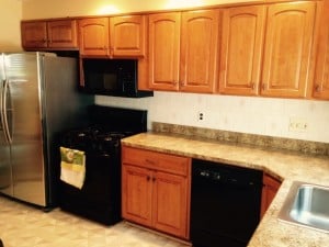 New cabinet installed over refrigerator.